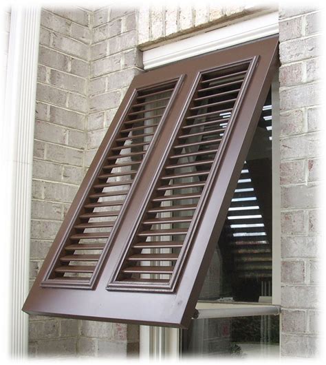 house with shutters with metal tieback|hanging outdoor shutters at home.